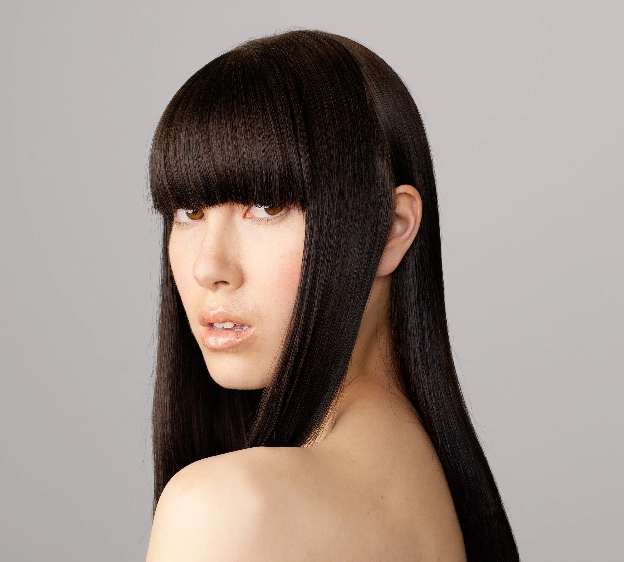 Studio portrait of Lauren with straight fringe from the series 'Curiosity' by photographer David.A.Knight ©
