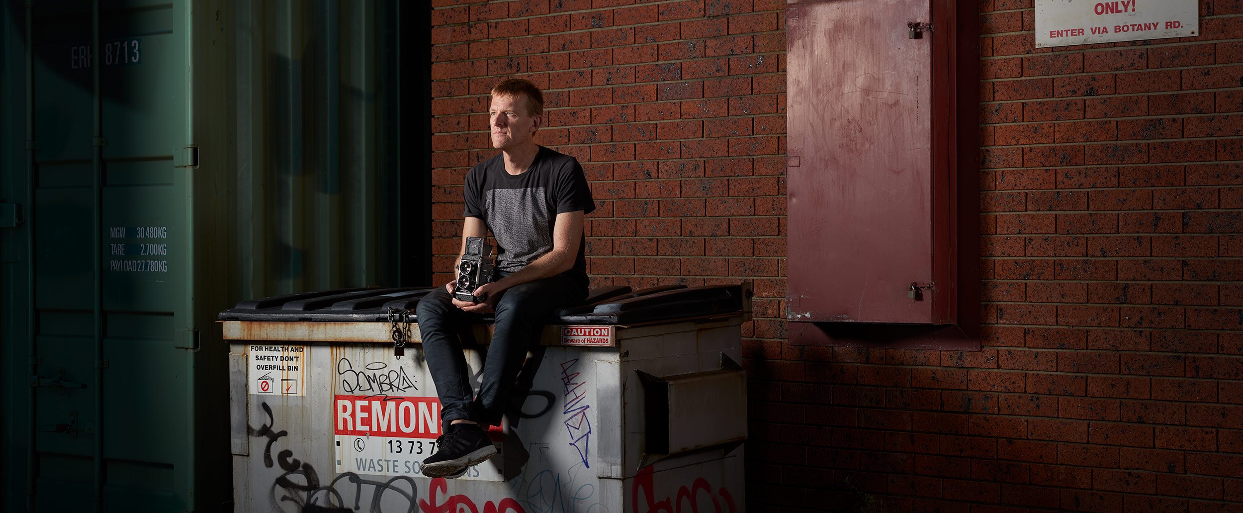 Location portrait  of Sydney photographer Michael Bradfield in the laneway outside his studio by photographer David.A.Knight ©