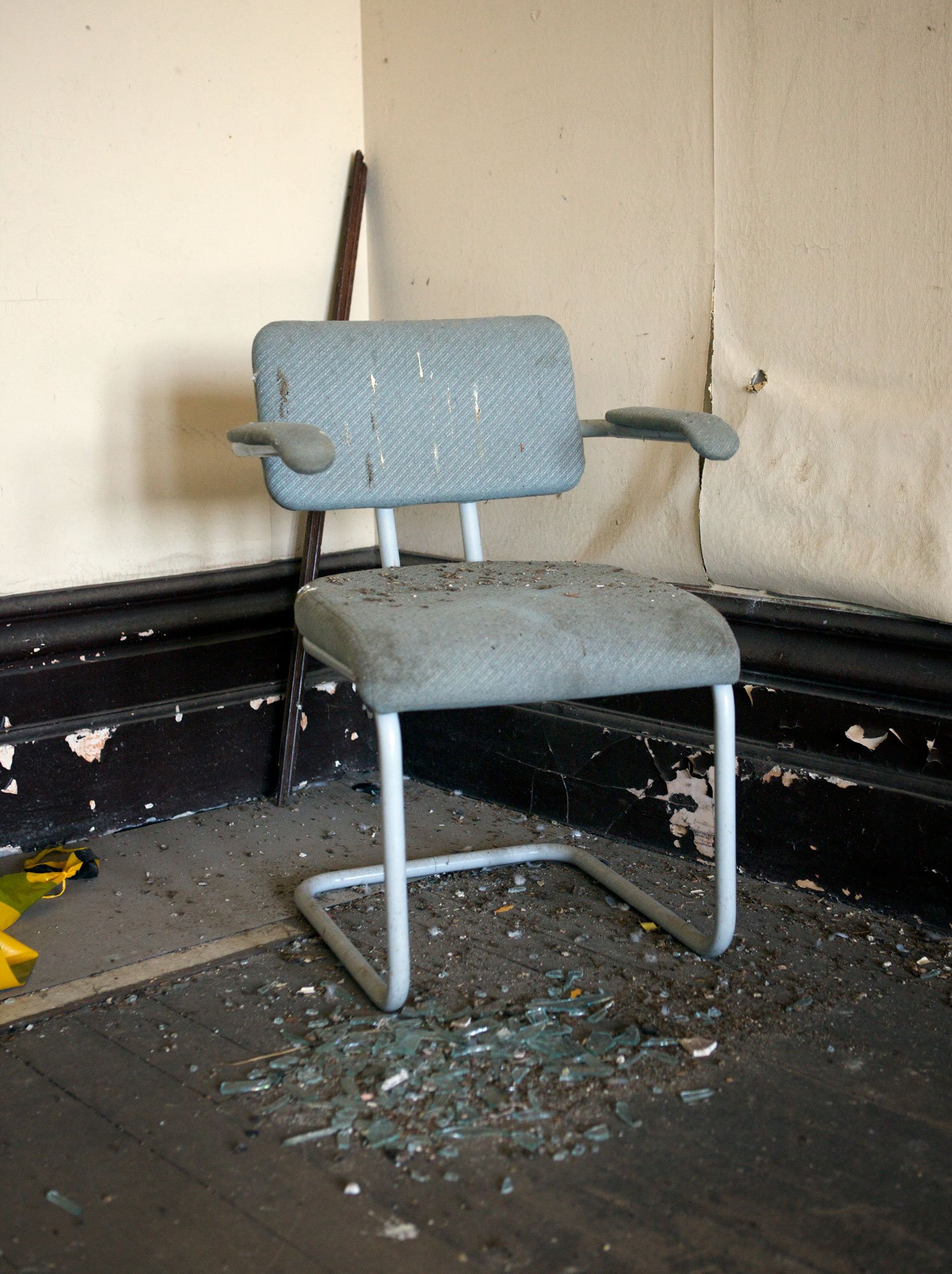 Room interior with old chair and  broken glass from the series 'Broken' by photographer David.A.Knight ©