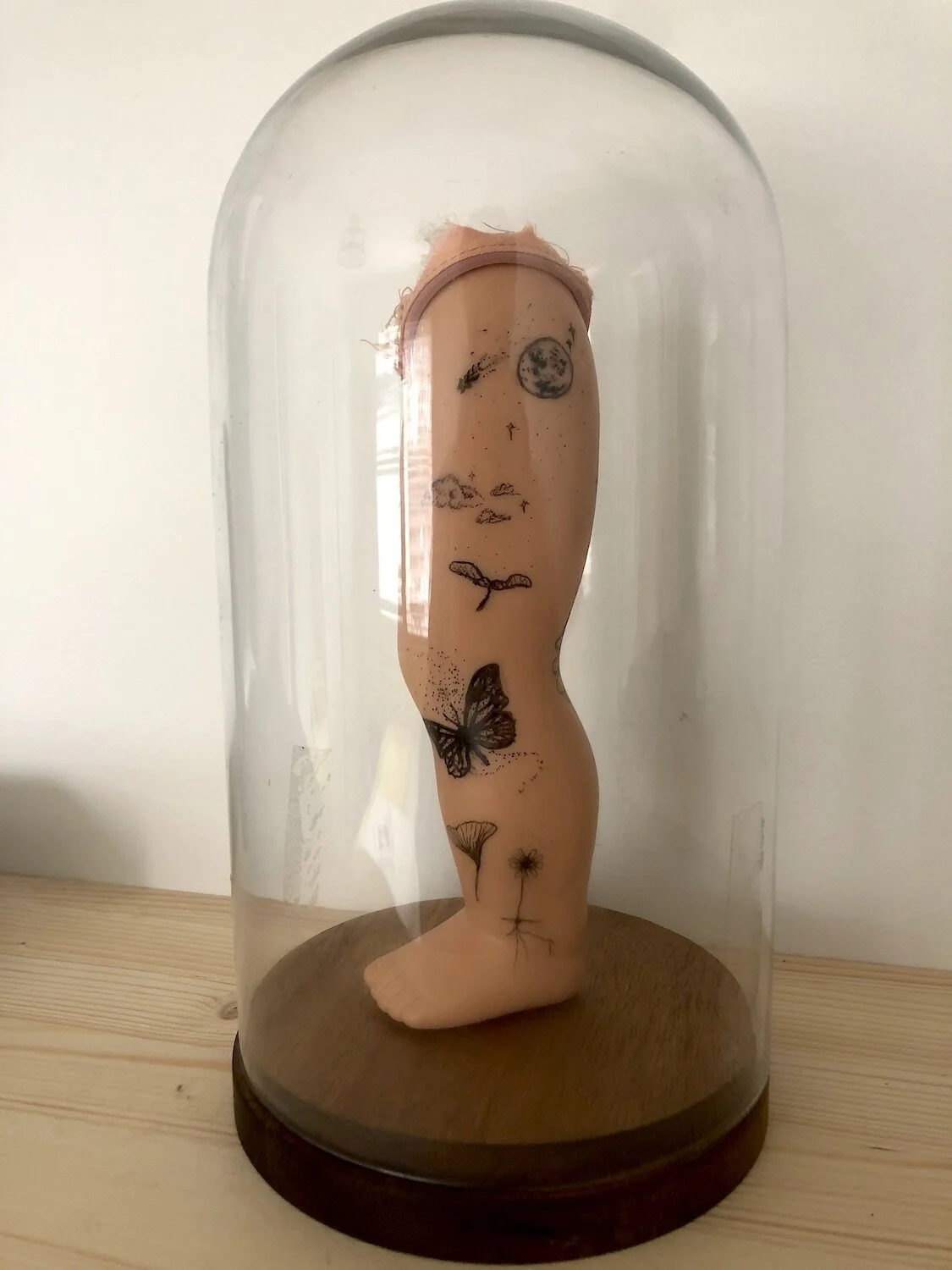 ROBERT OWEN, 3RD YEAR, FINDERS KEEPERS, RECLAIMED BABY DOLL LEG WITH FELT TIP MARKER AND CLOCHE WITH WOODEN BASE, CLOCHE WITH BASE (H 10 ¾” X C 17 1/8”) BABY DOLL LEG (L 2 1/8” X H 7 5/8” X C 5 ½”), 2020