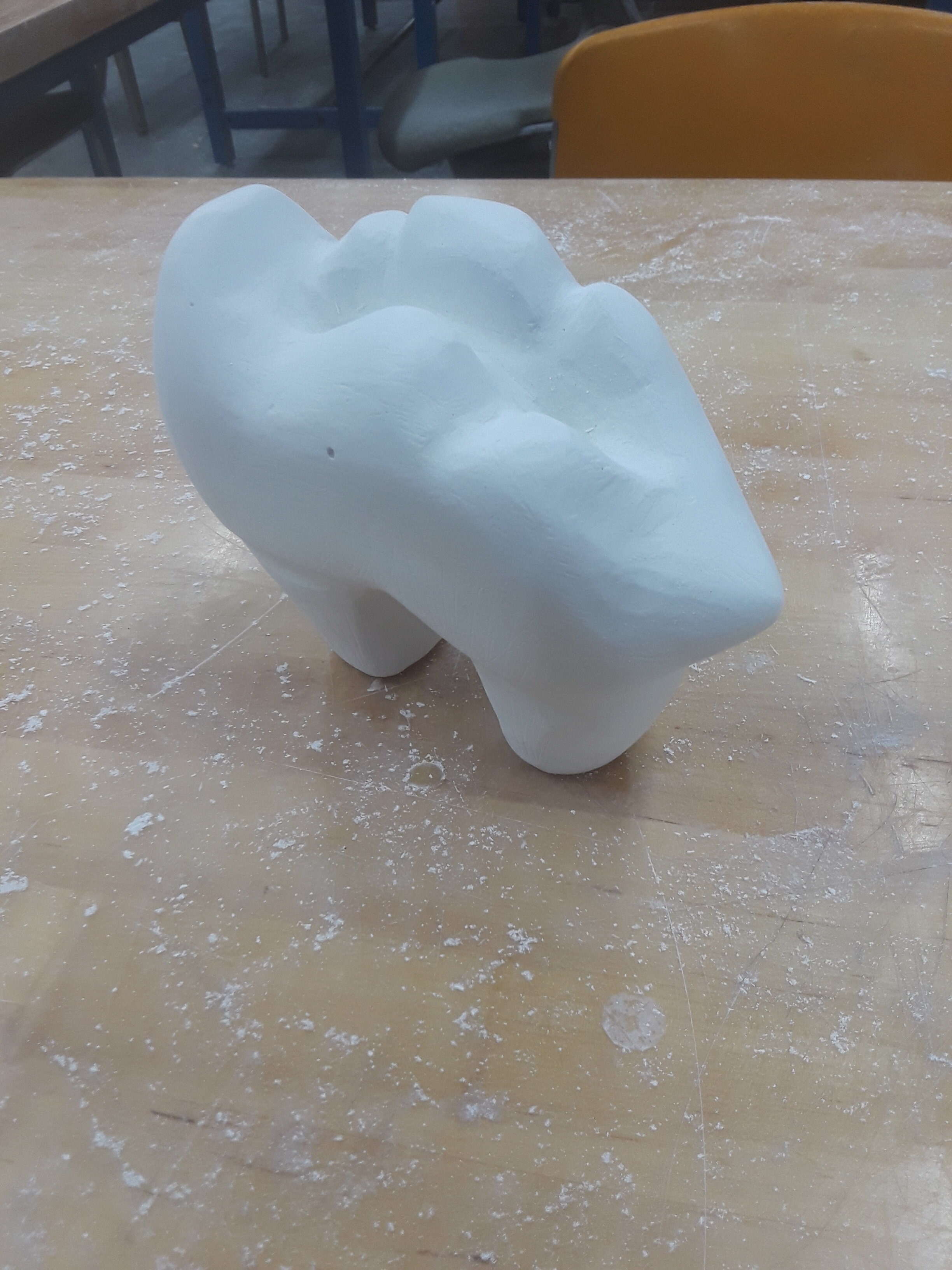 A carved plaster canine's molar. Made as a project for a 3D concepts class.