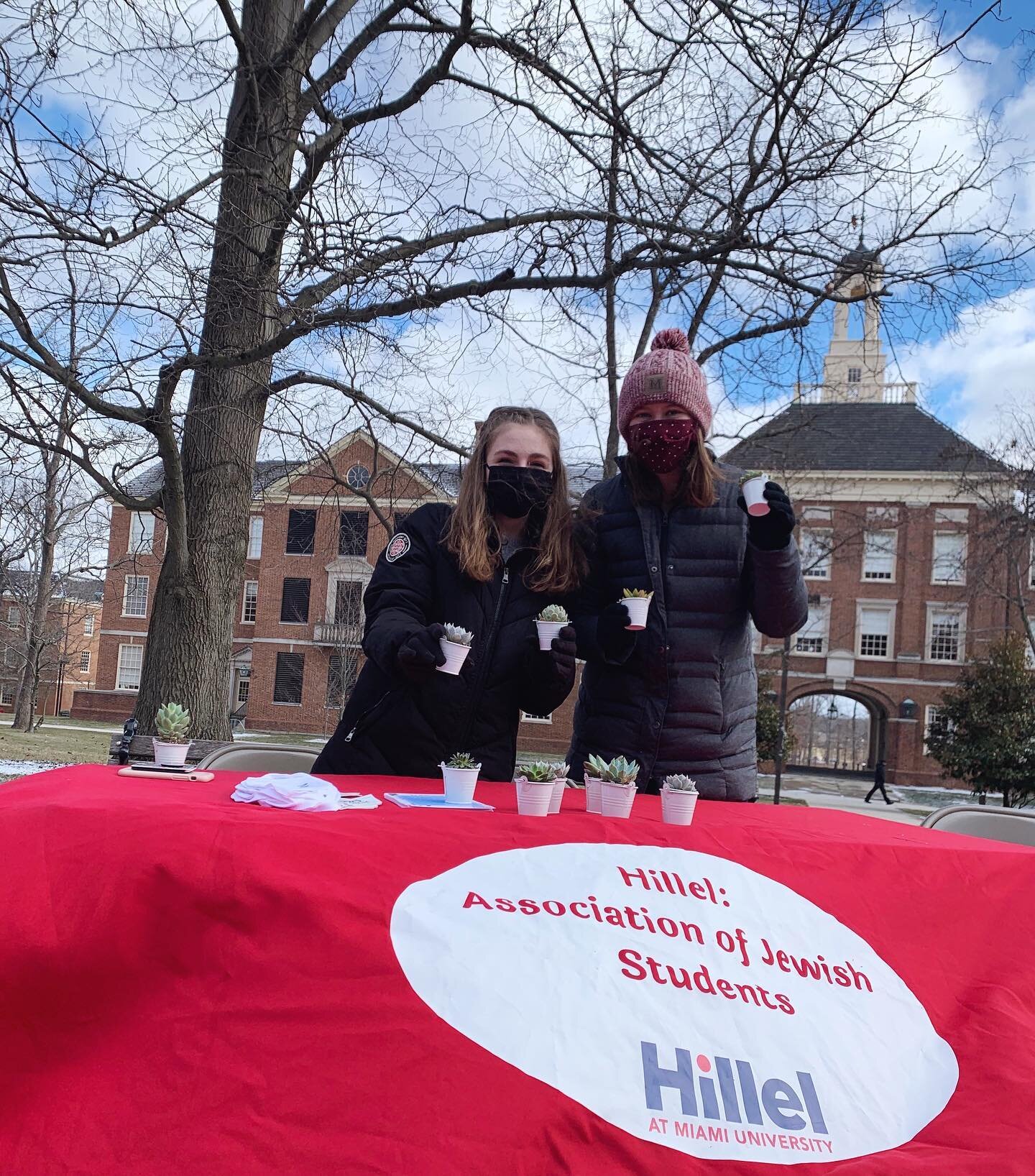 The cold didn&rsquo;t stop us from celebrating Tu B&rsquo;Shevat today!

Image descriptions: 
Slide 1: photo of 2 students at the seal in front of a table with succulents 
Slide 2: photo of succulents on table next to Tu B&rsquo;Shevat handouts