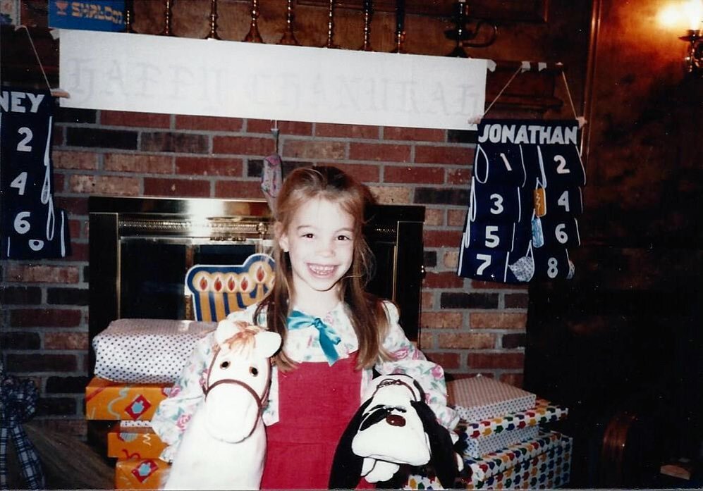 Can you guess that kid?!? It&rsquo;s our Executive Director, Whitney Fisch, living her best life as a 5 year-old in 1985. 2 Pound Puppies! Score! Send us your old school Hanukkah pics! We&rsquo;d love to share!