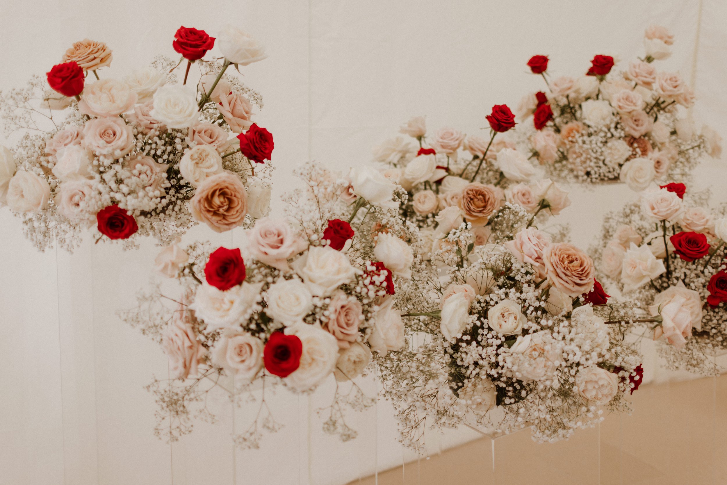 Modern chic wedding flowers on clear perspex plinths.jpg