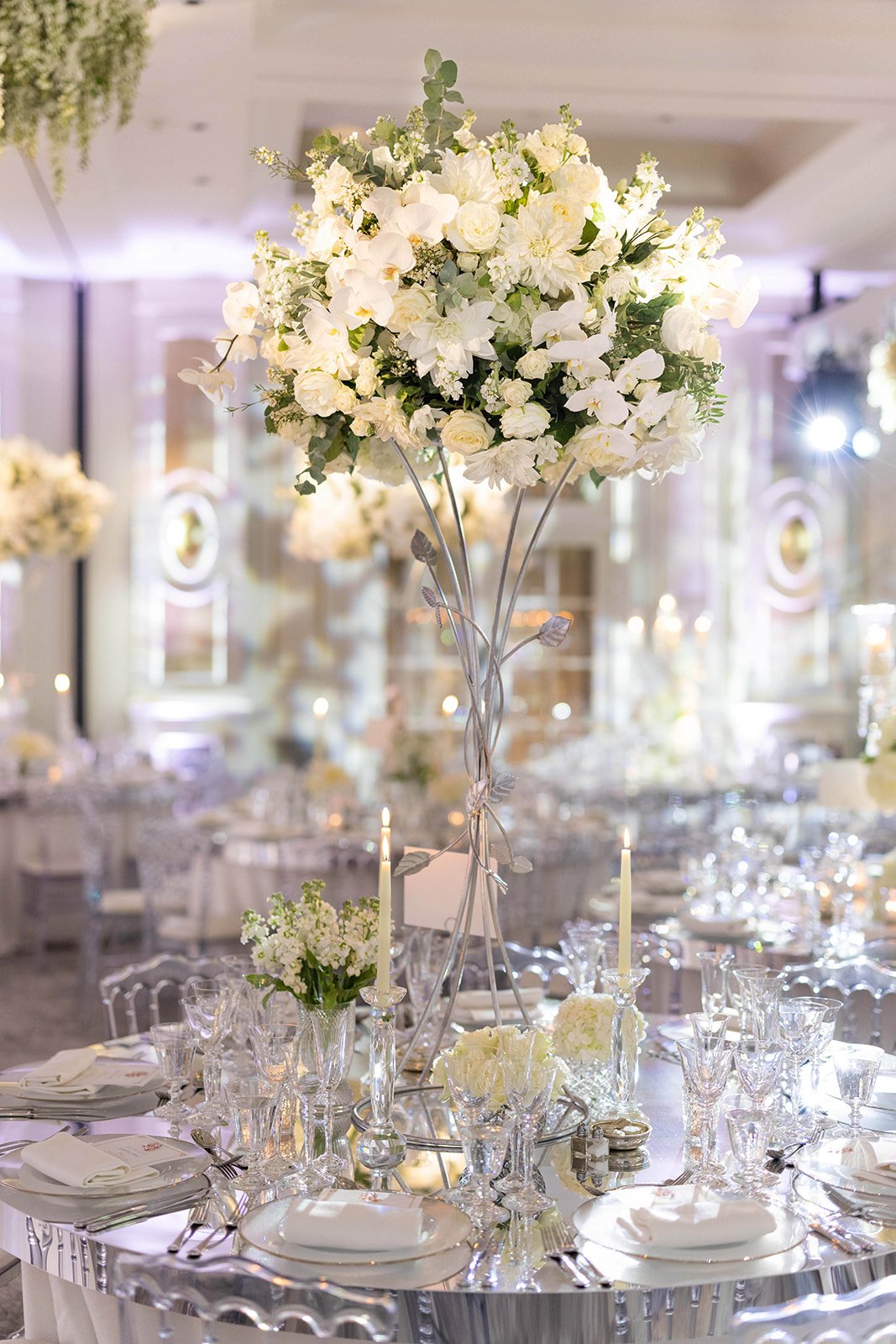 Tall white flower arrangement on silver mirror table.jpg