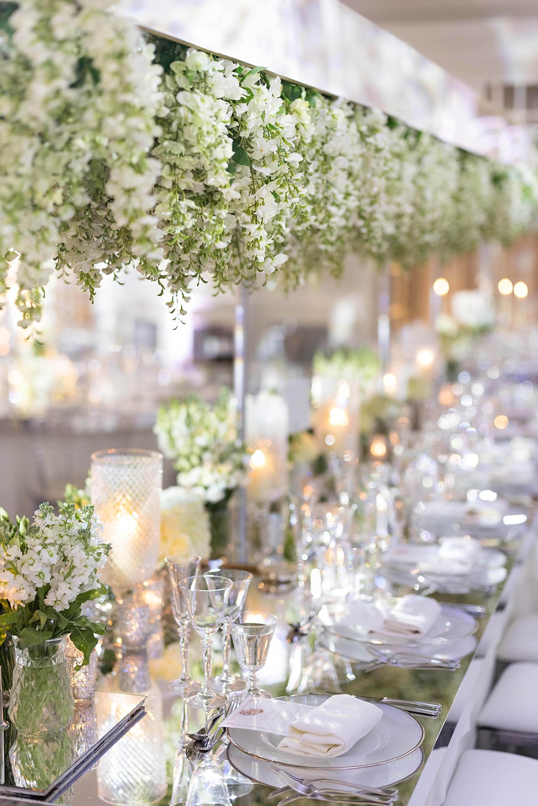 Silver mirror long top table, overhead hanging flowers.jpg