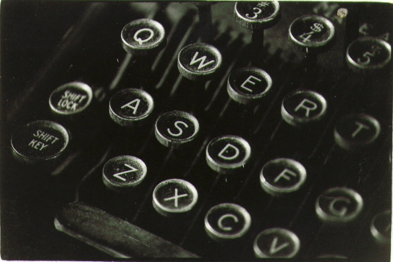 Close-up of vintage typewriter keys showing letters and symbols.