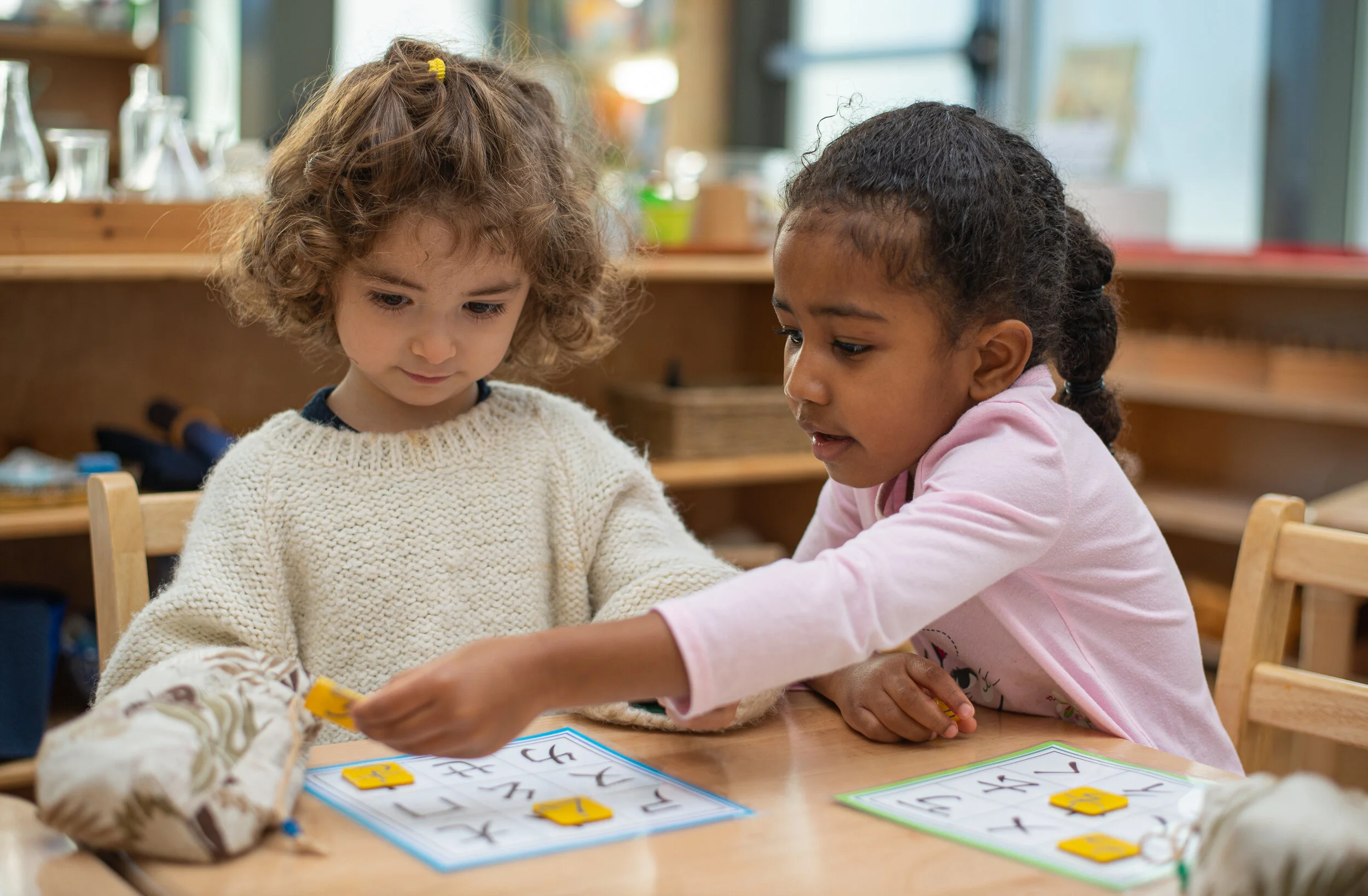 Two primary children working on the Chinese phonetic alphabet