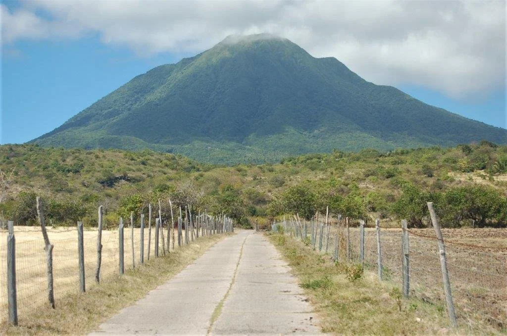a road running straight into the distance with Nevis Peak in the background 