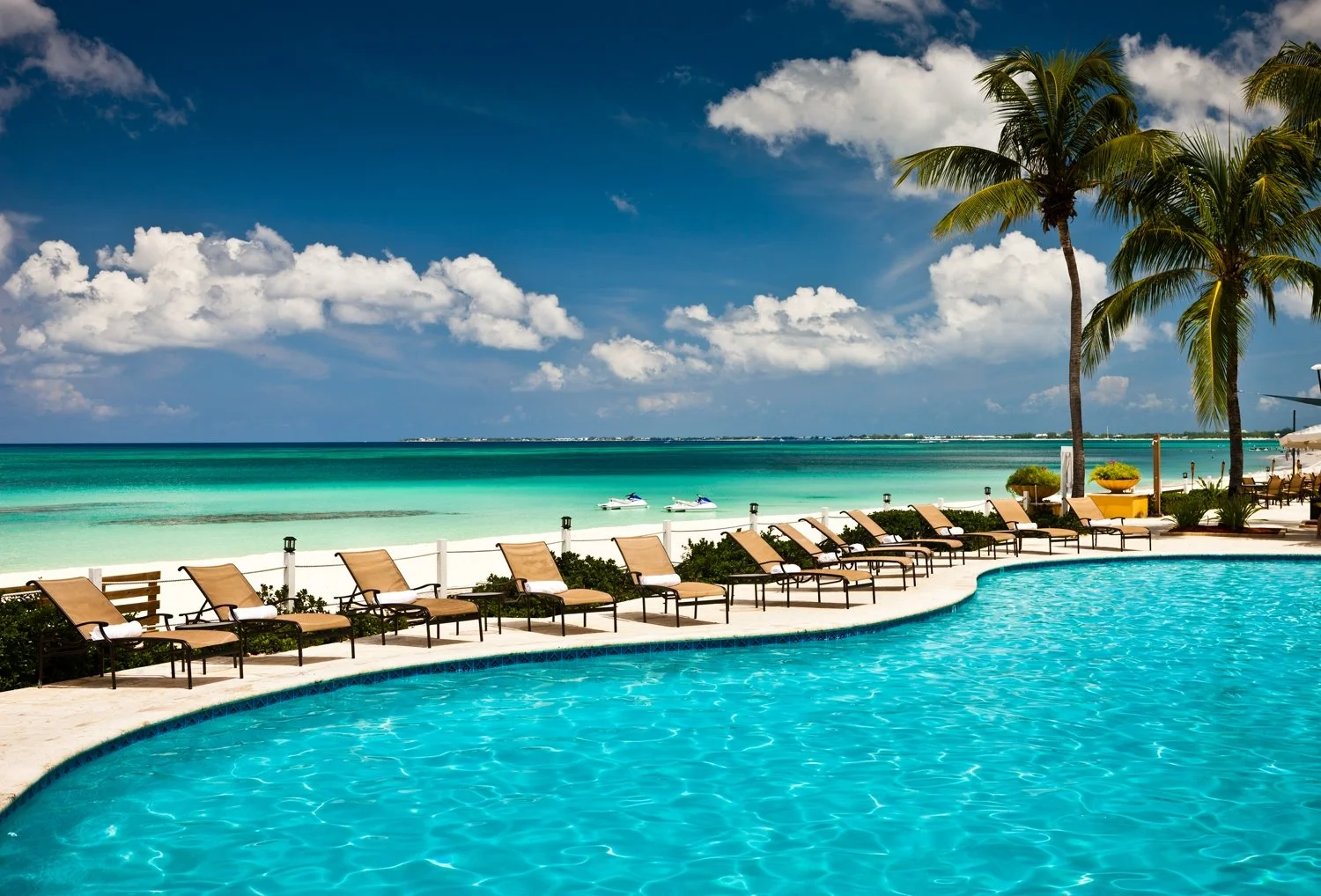 loungers between the pool and sea on Grand Cayman 