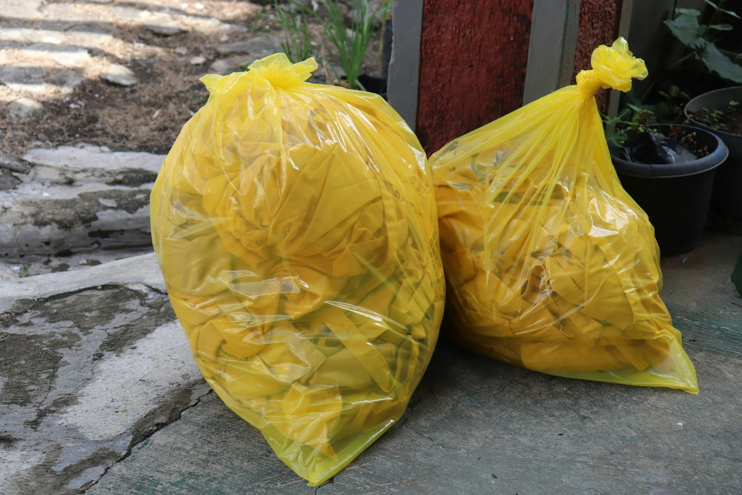 Two yellow bags of waste