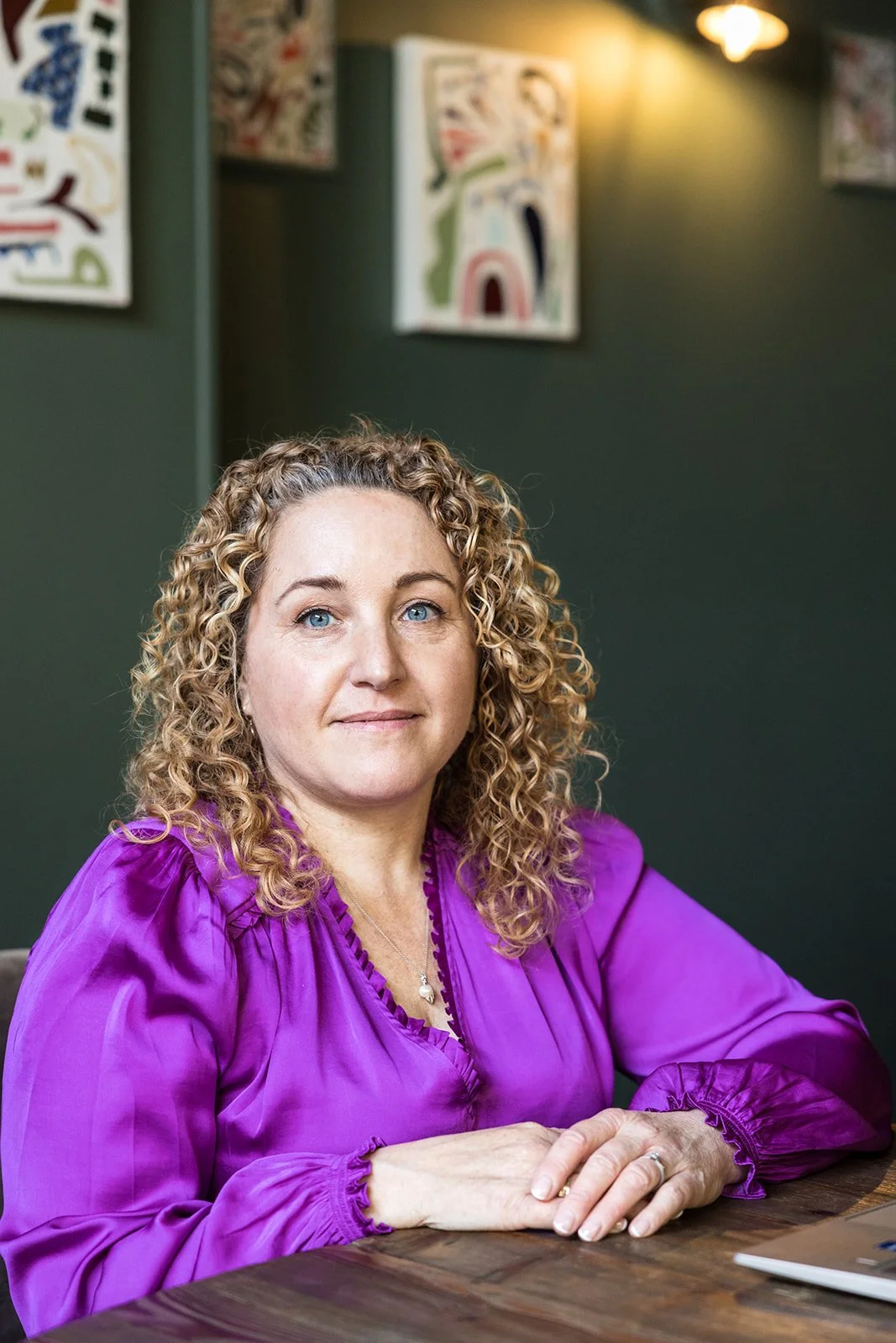 A lady with long curly blond hair