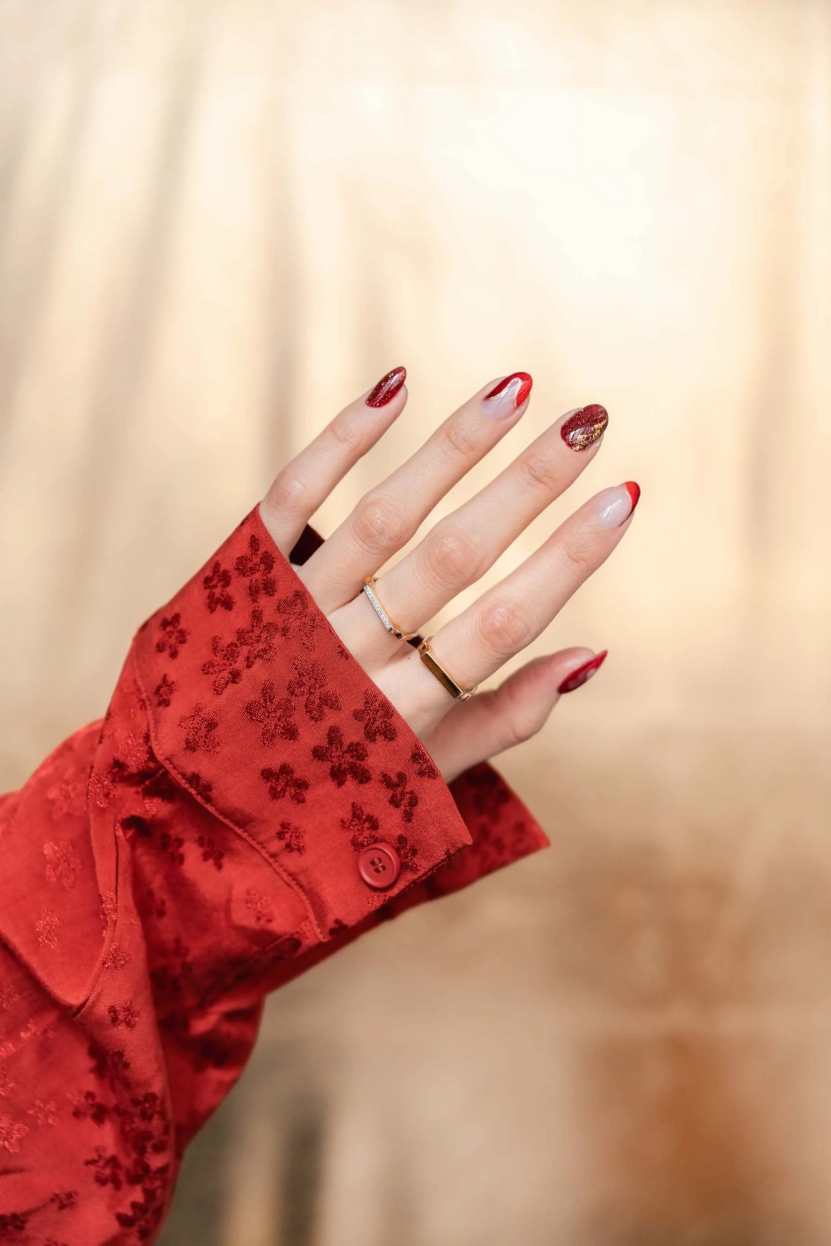 A Becoming Carmen Chinese New Year manicure featuring a red and gold nail design inspired by the Year of the Snake.