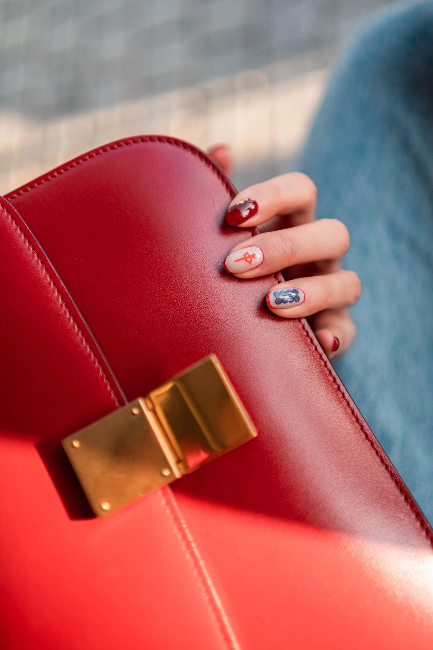 A Becoming Carmen Lunar New Year manicure featuring a mahjong tile nail design with red and green accents.