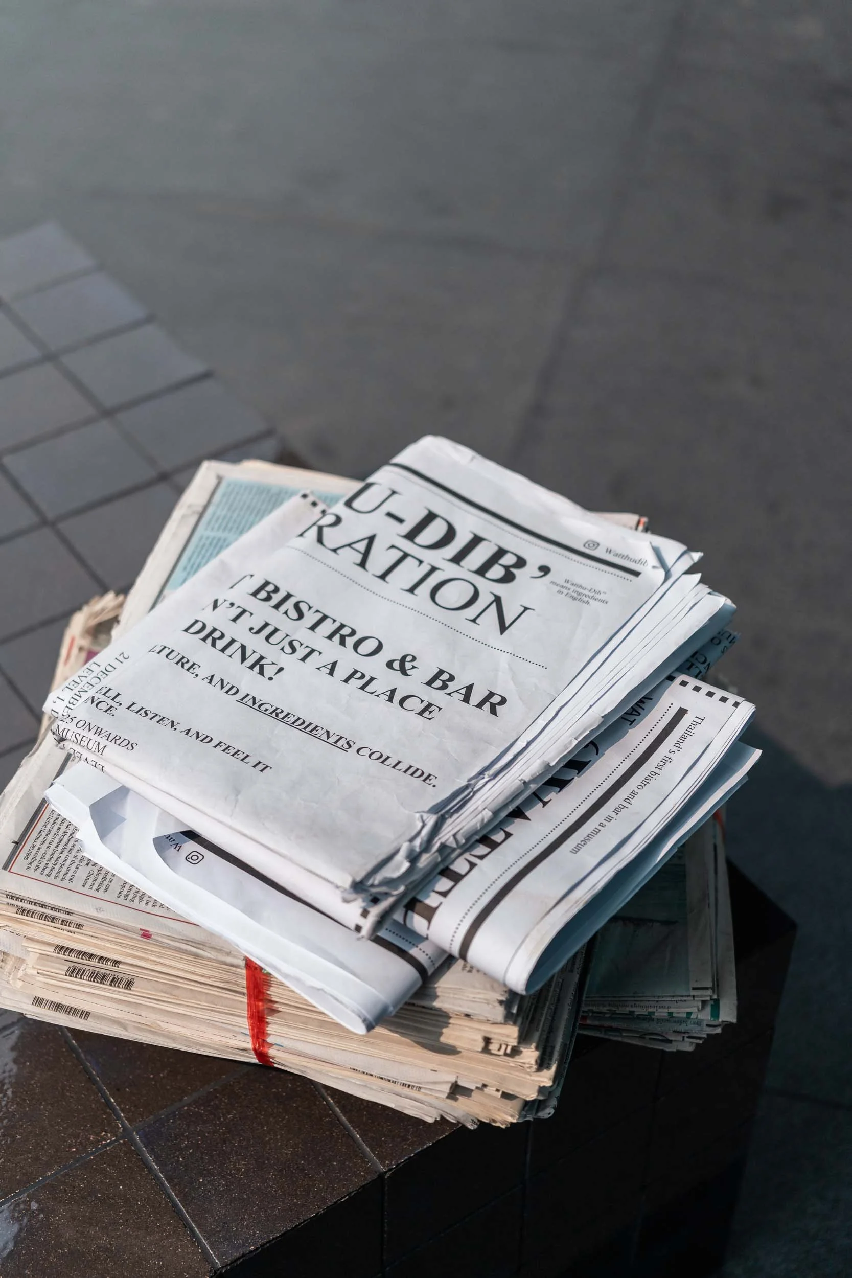 Newspaper stack at Dib Bangkok