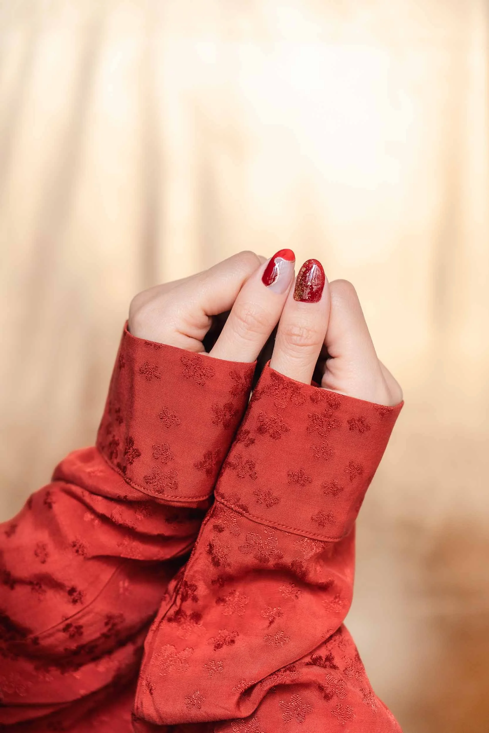 A Becoming Carmen Chinese New Year manicure featuring a red and gold nail design inspired by the Year of the Snake.