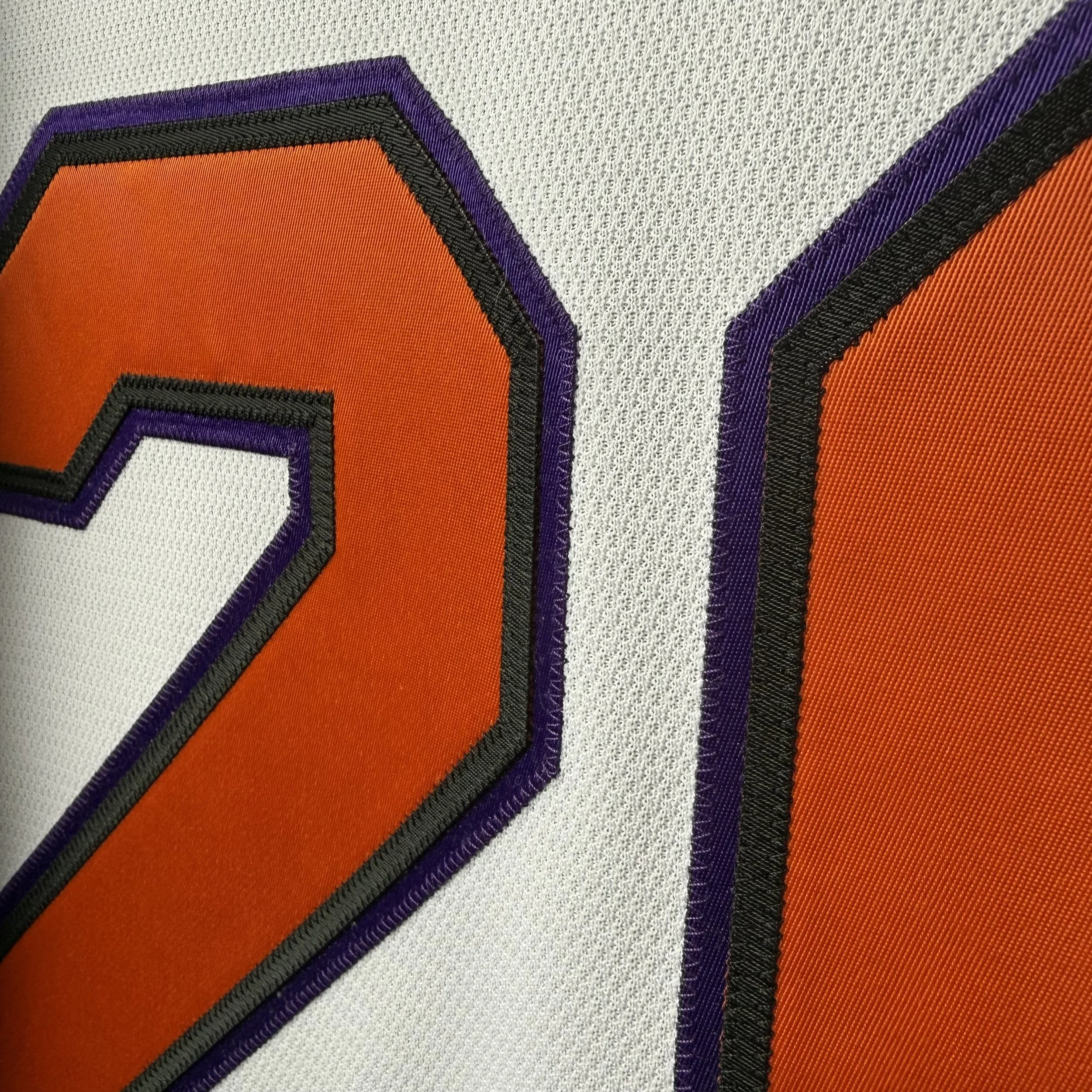 Sewn orange, black, and purple tackle-twill layers on a wedding jersey