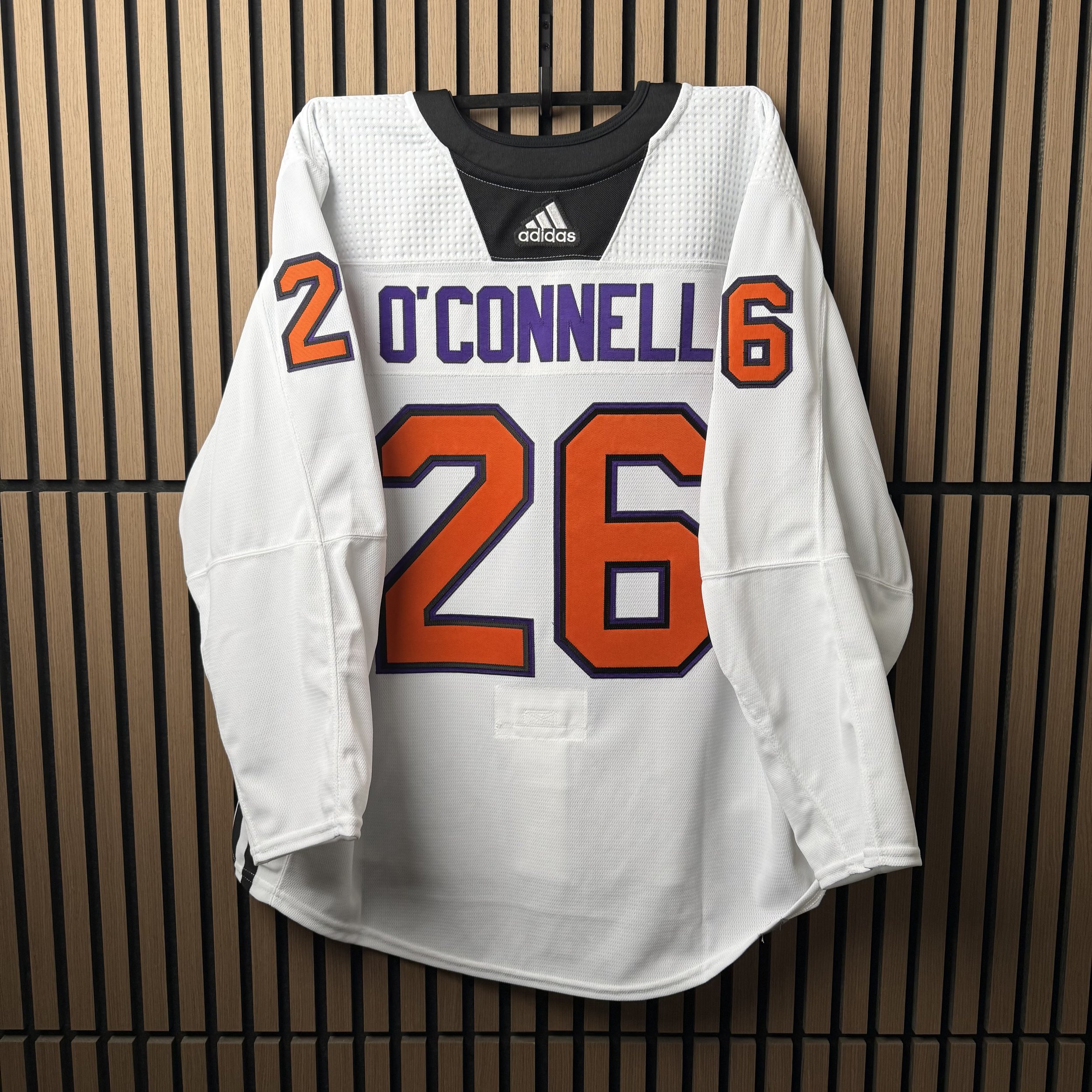 Custom O'Donnell 26 hockey wedding jersey on a wood backdrop