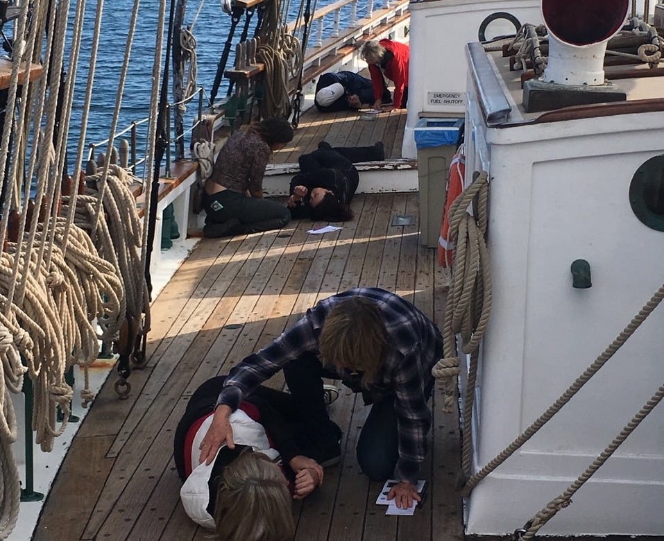   Student pairs engaging in a simulated scenario to practice addressing common emergencies at sea.  