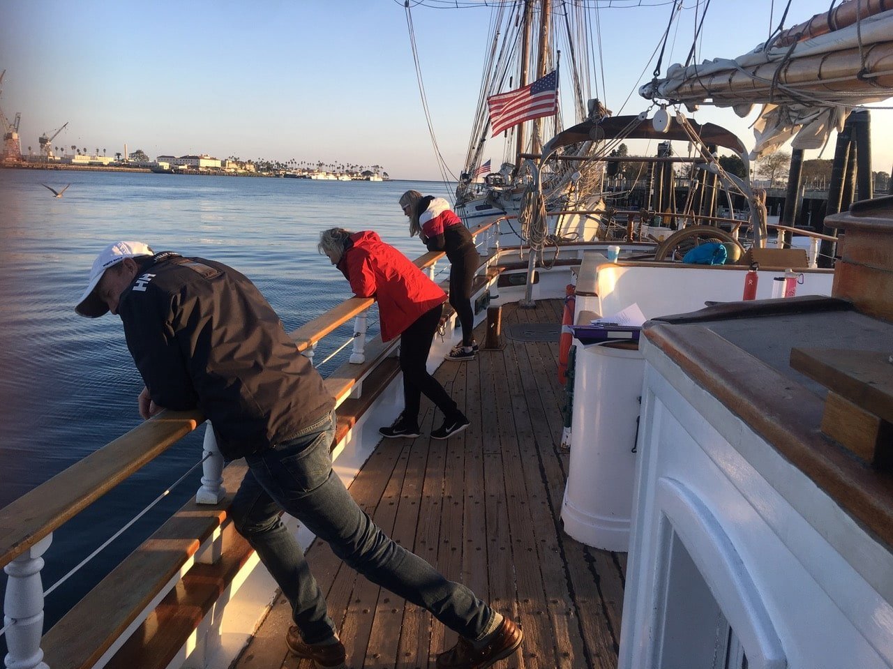   Students in our Los Angeles Advanced First Aid/CPR for Mariners course peering over the side of the sailboat.  