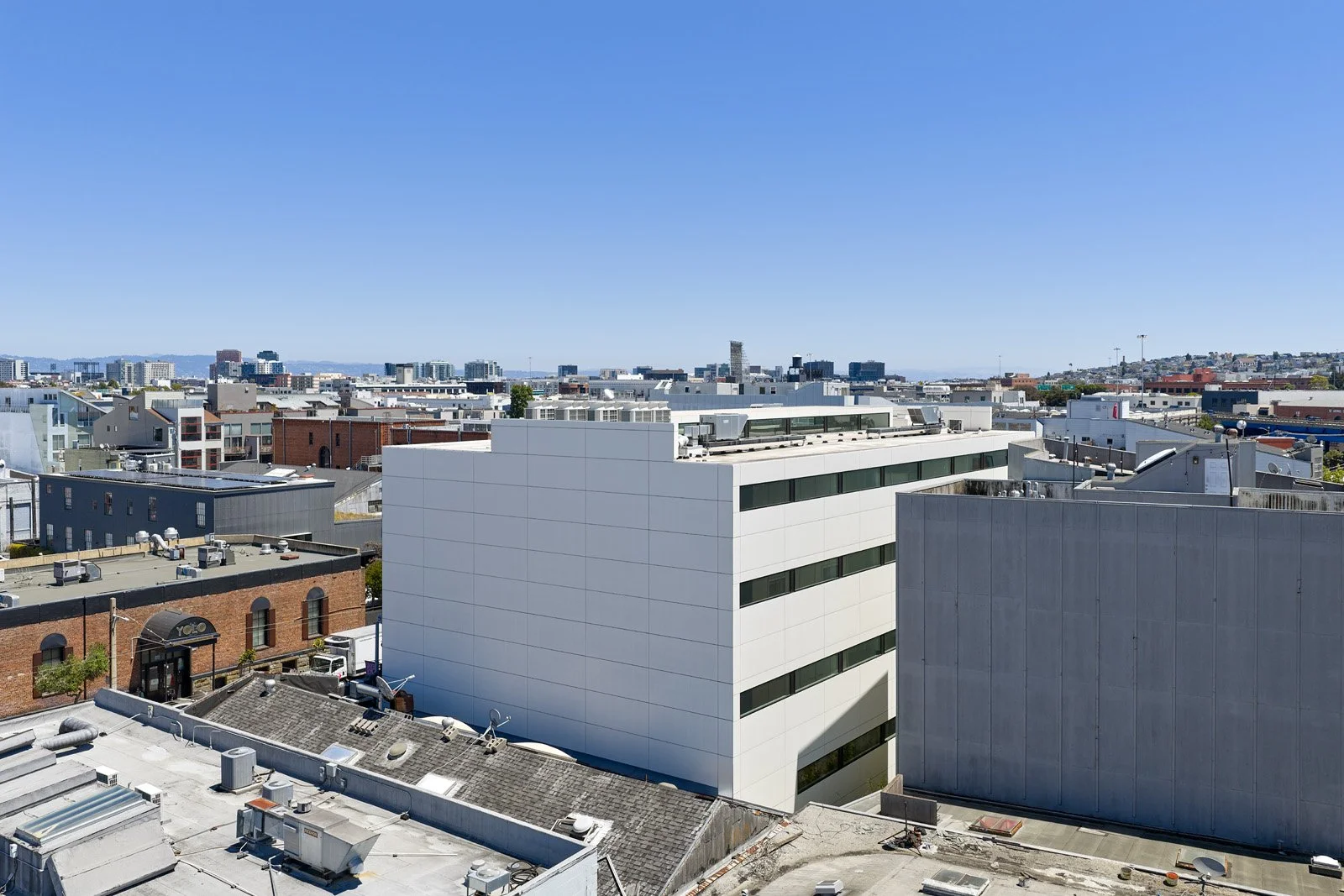 Cityscape with modern buildings and a clear blue sky.