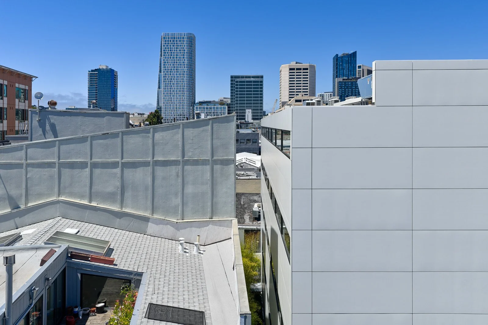 Cityscape view with high-rise buildings and rooftops in downtown area.