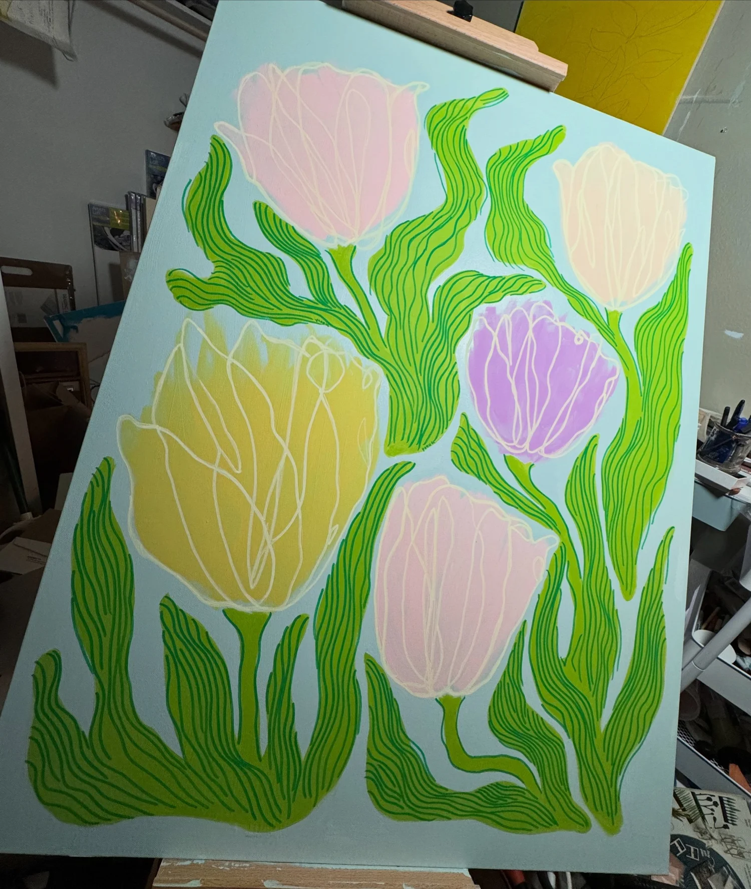 Tulips on Parade by Dustin Young, pastel tulips and green leaves on a blue ground, photographed on an easel.