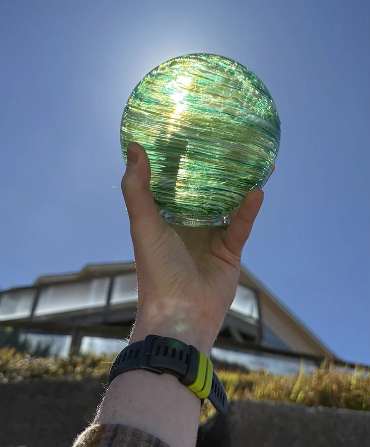 hand holding up a glass float