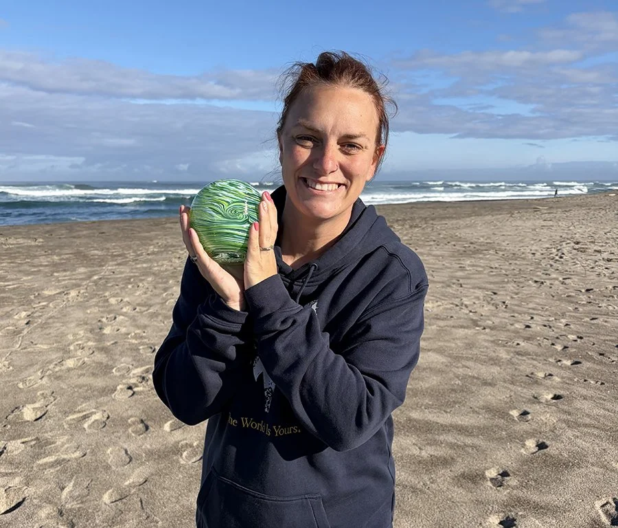 Woman happily holding her found glass float