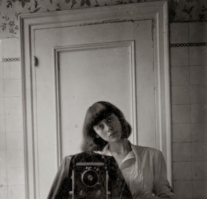 female photographer portrait in mirror.jpeg