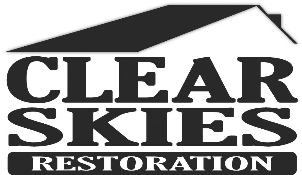 Black and white logo for Clear Skies Restoration with a stylized roof above the text.