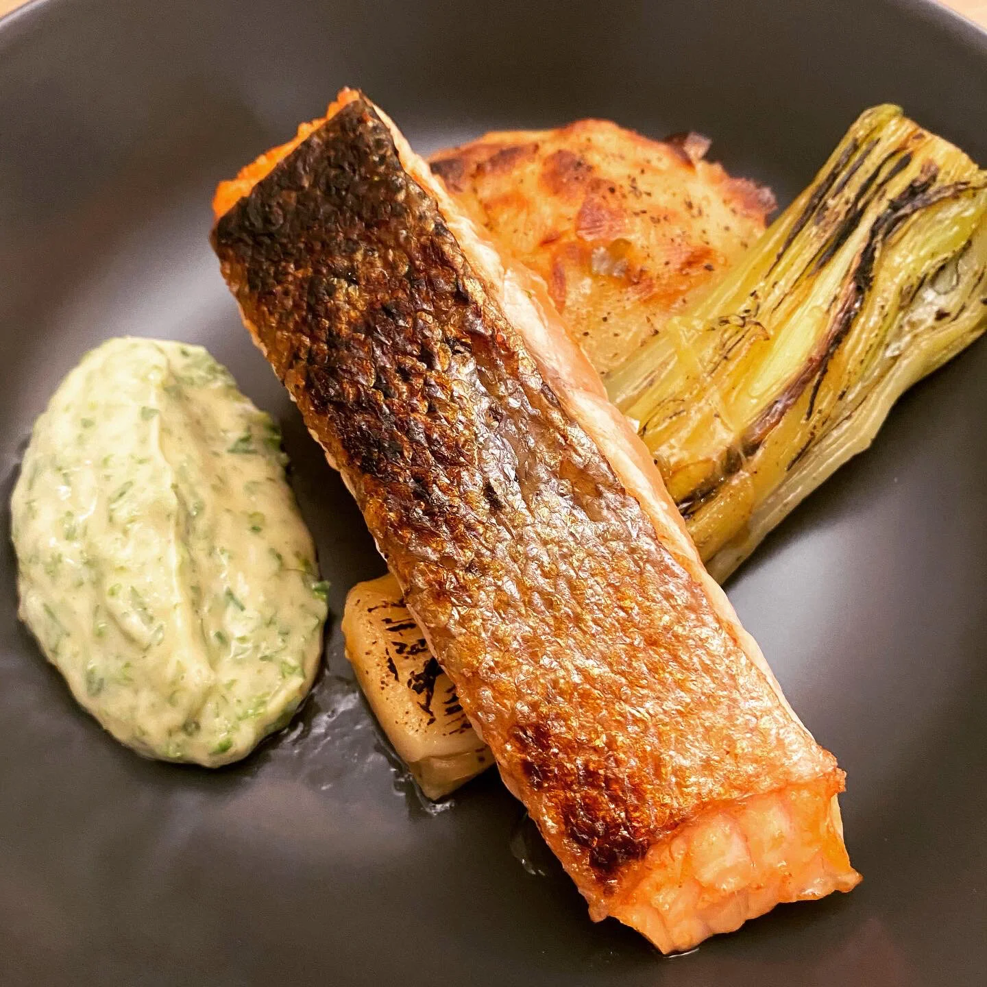 Salmon, potato galette &amp; braised leeks finished with a blowtorch with a parsley mayonnaise  