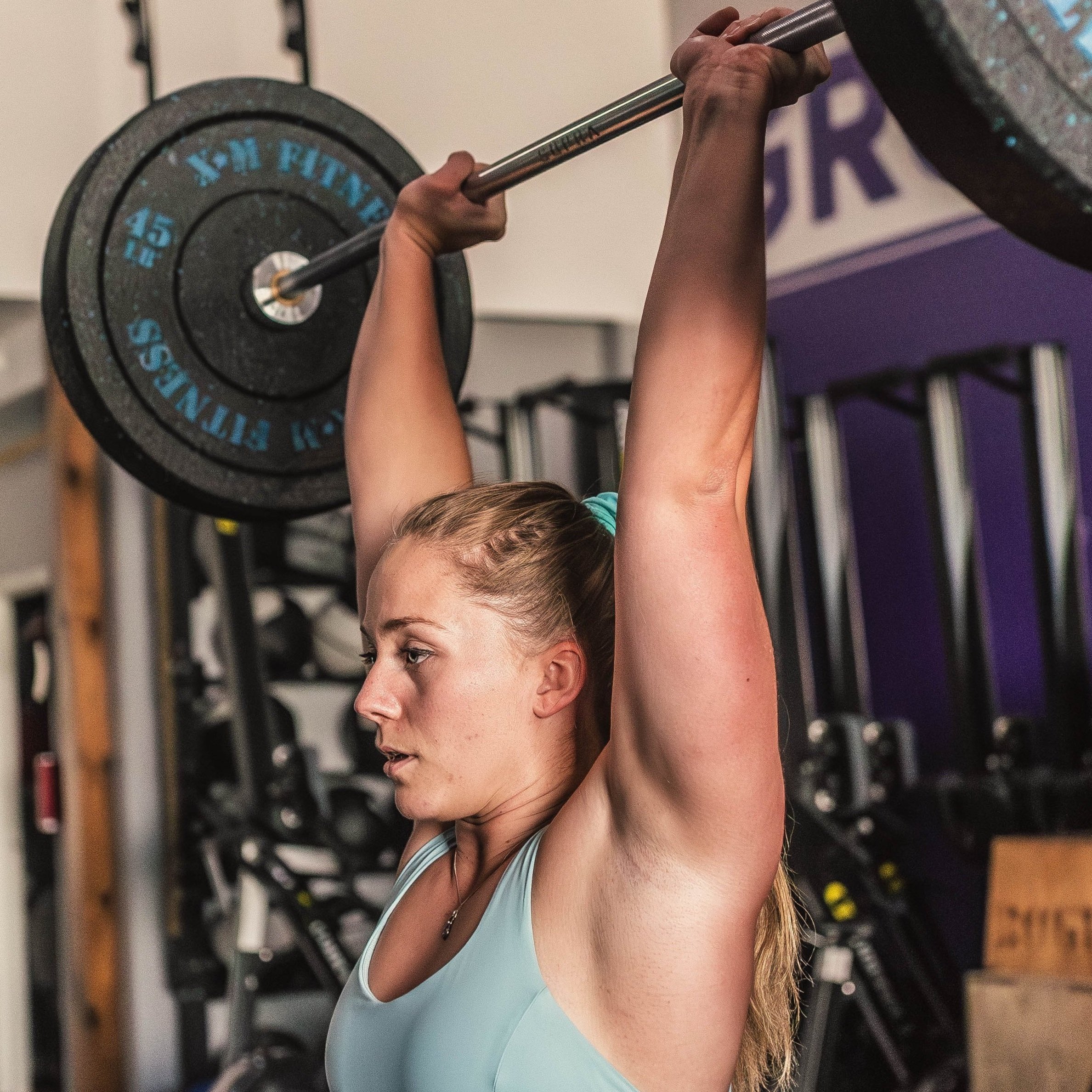 Nicole lifting weights in gym