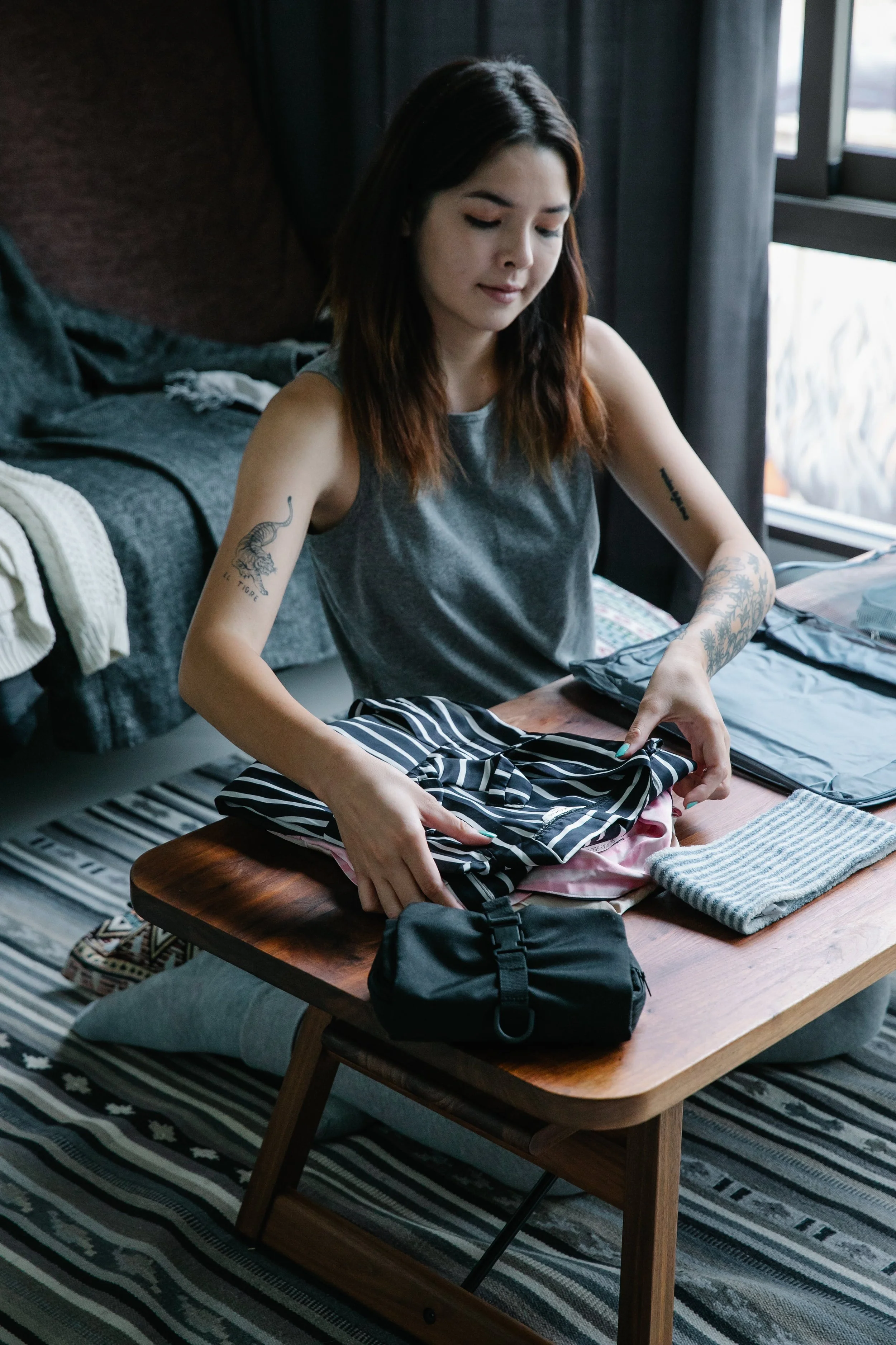 Woman folding clothes on table