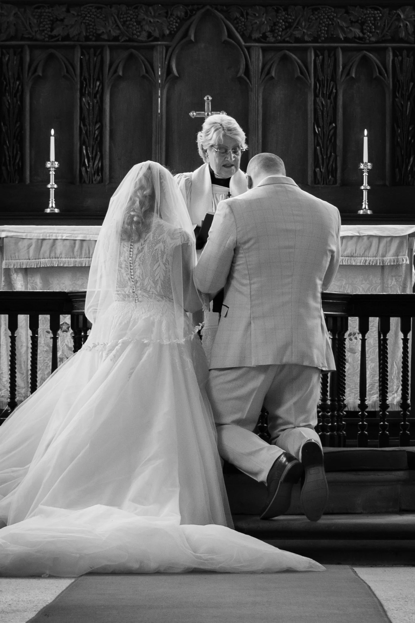 Bride and groom standing at the alter at Wilford Church in Nottingham