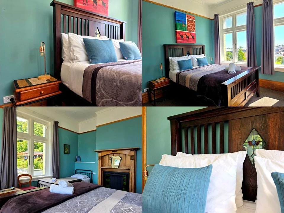 Stylish wooden bed with extra pillows and bedside tables. Large windows with nice views.