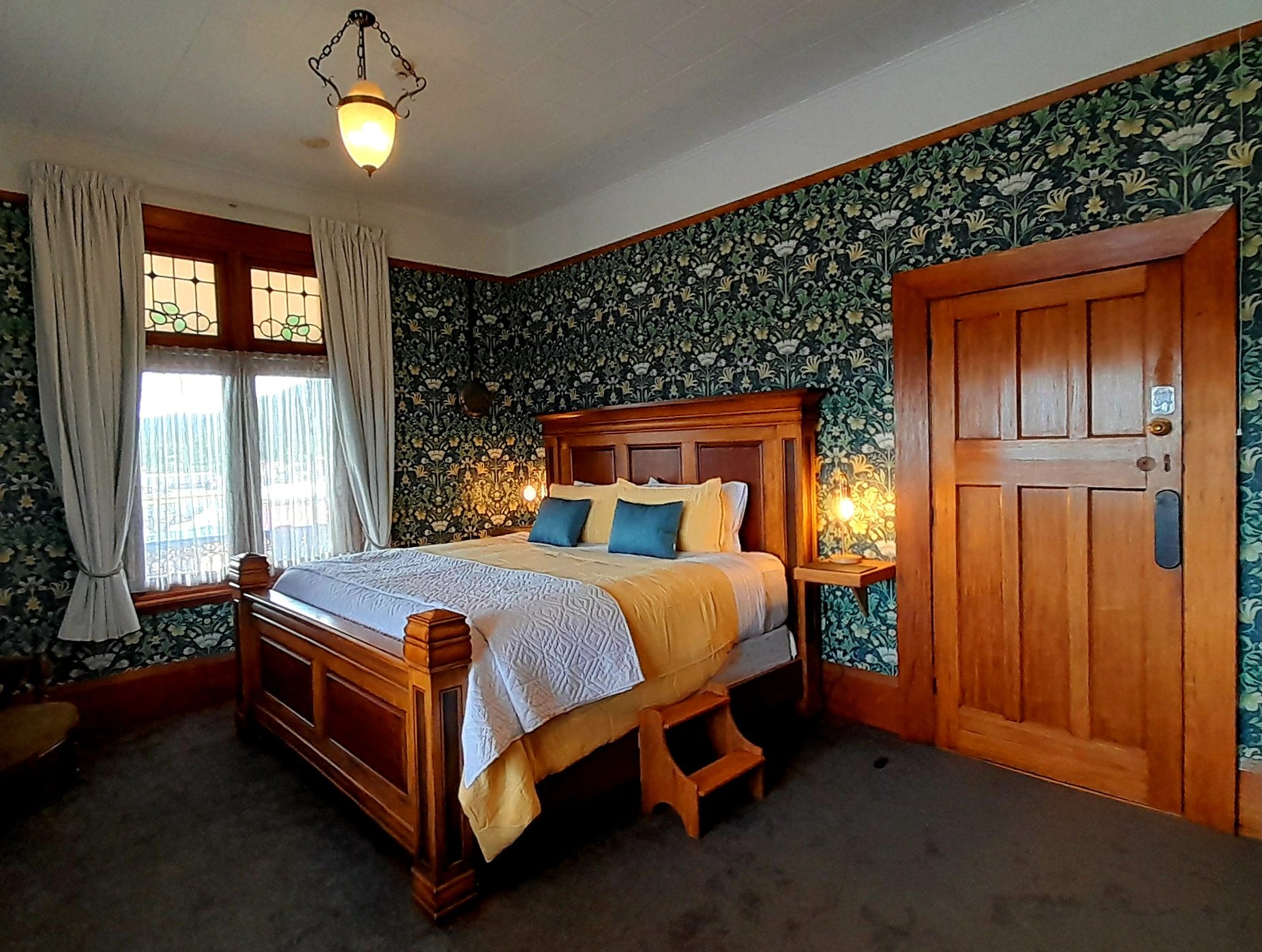 Delux boutique room at Noah's Ark Flashpacker featuring stylish wooden California king-size bed.