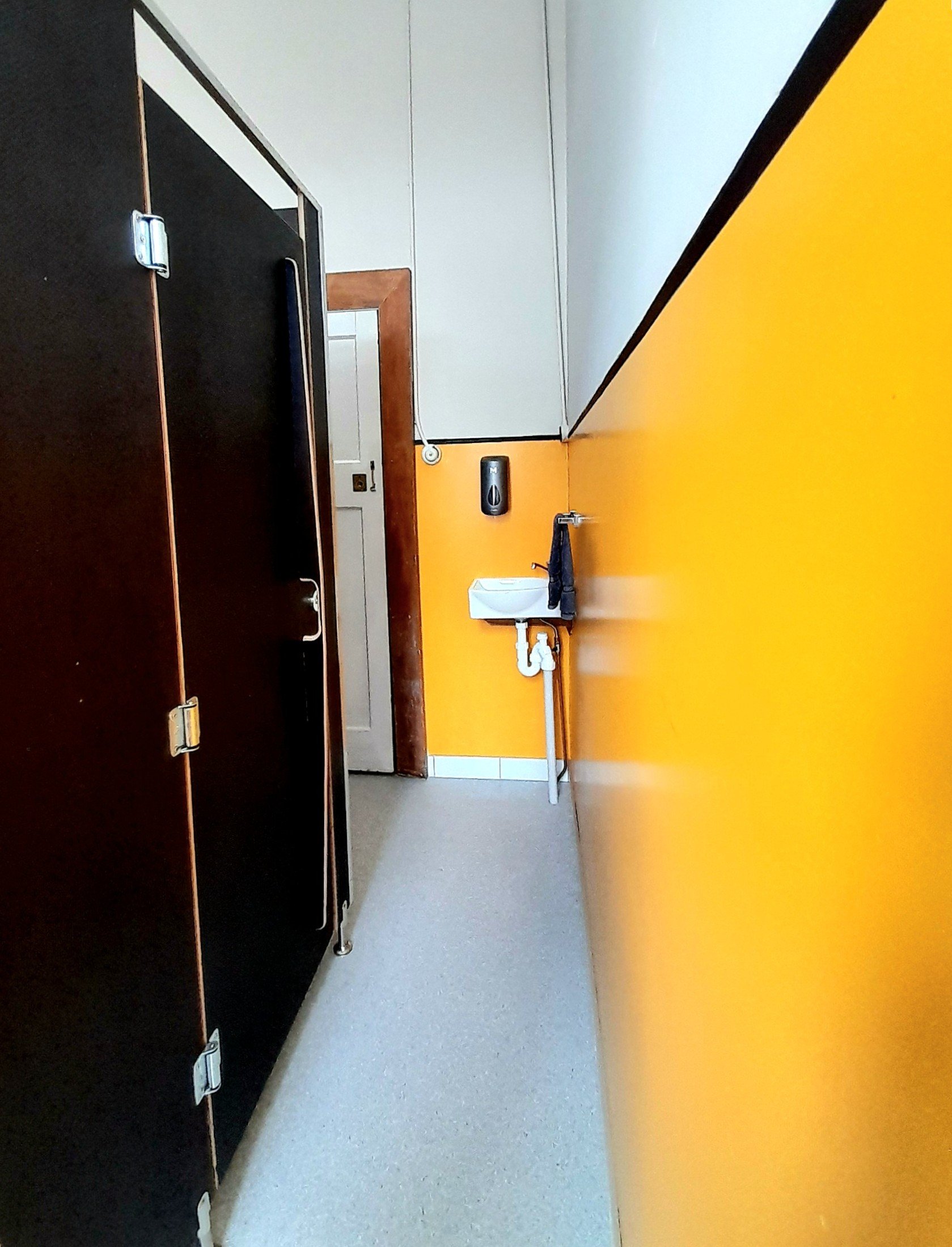 Toilet - view towards the entry door and basin.