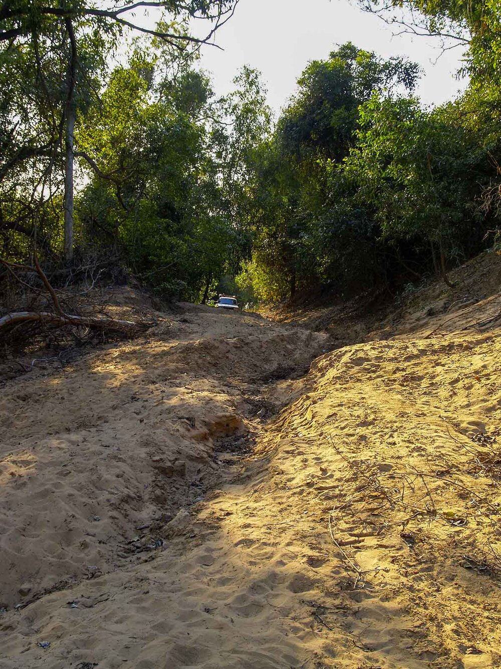 Road approaching the crossing, in poor condition