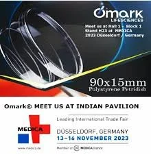 Event banner for Omark at Indian Pavilion, Düsseldorf, Germany, from November 13 to 16, 2023, showcasing a large, abstract metallic design and event details.
