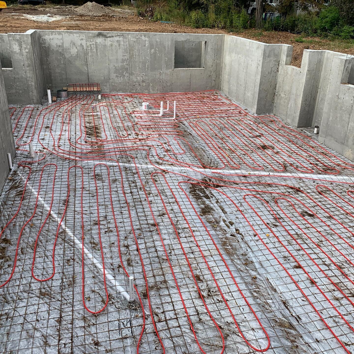 Radiant heat systems are known to be energy efficient, quiet, hypoallergenic and space saving, so you don&rsquo;t compromise interior design factors in your home with bulky baseboard. 
Pictured is our installation of radiant heat on a basement slab. 