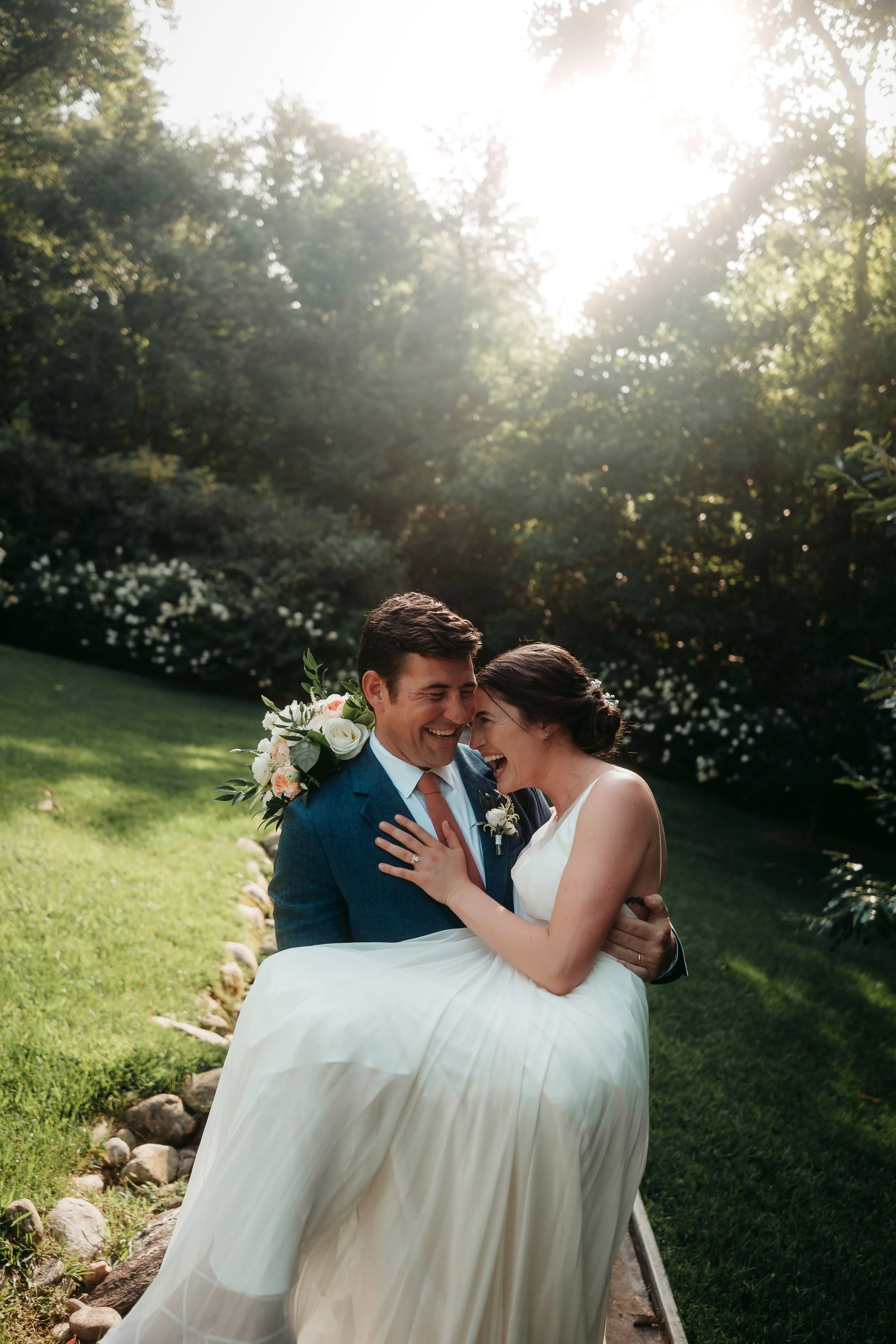 candid wedding shot of a couple laughing outdoors in North Carolina.