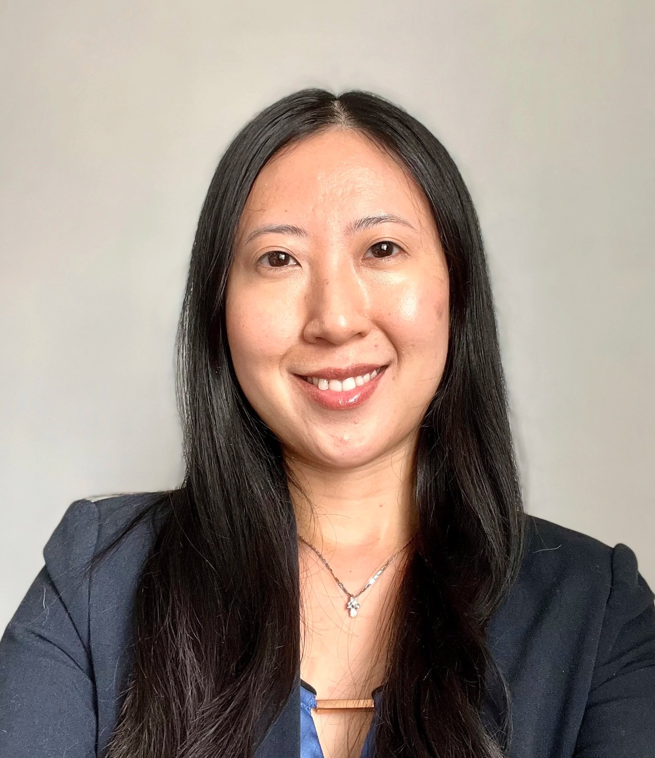 Portrait of Dr. May Liu, smiling with a neutral background