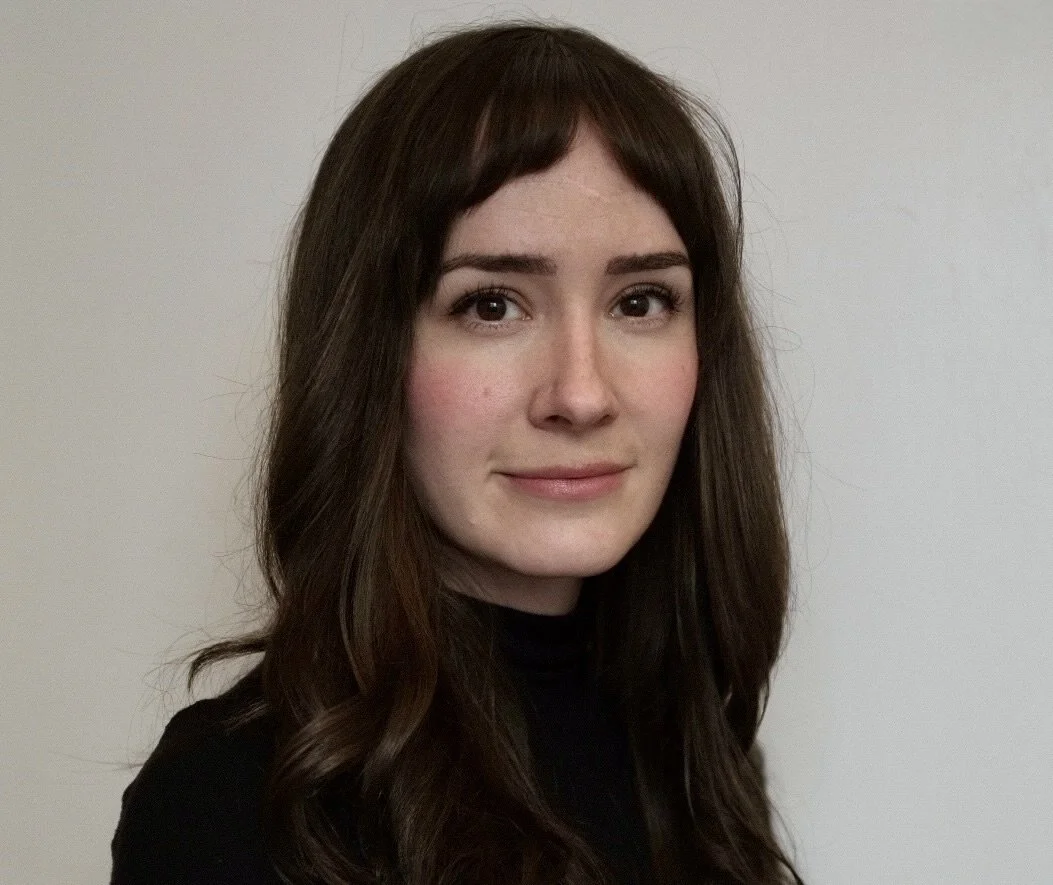 Portrait of Rachel Eirich, smiling with neutral background
