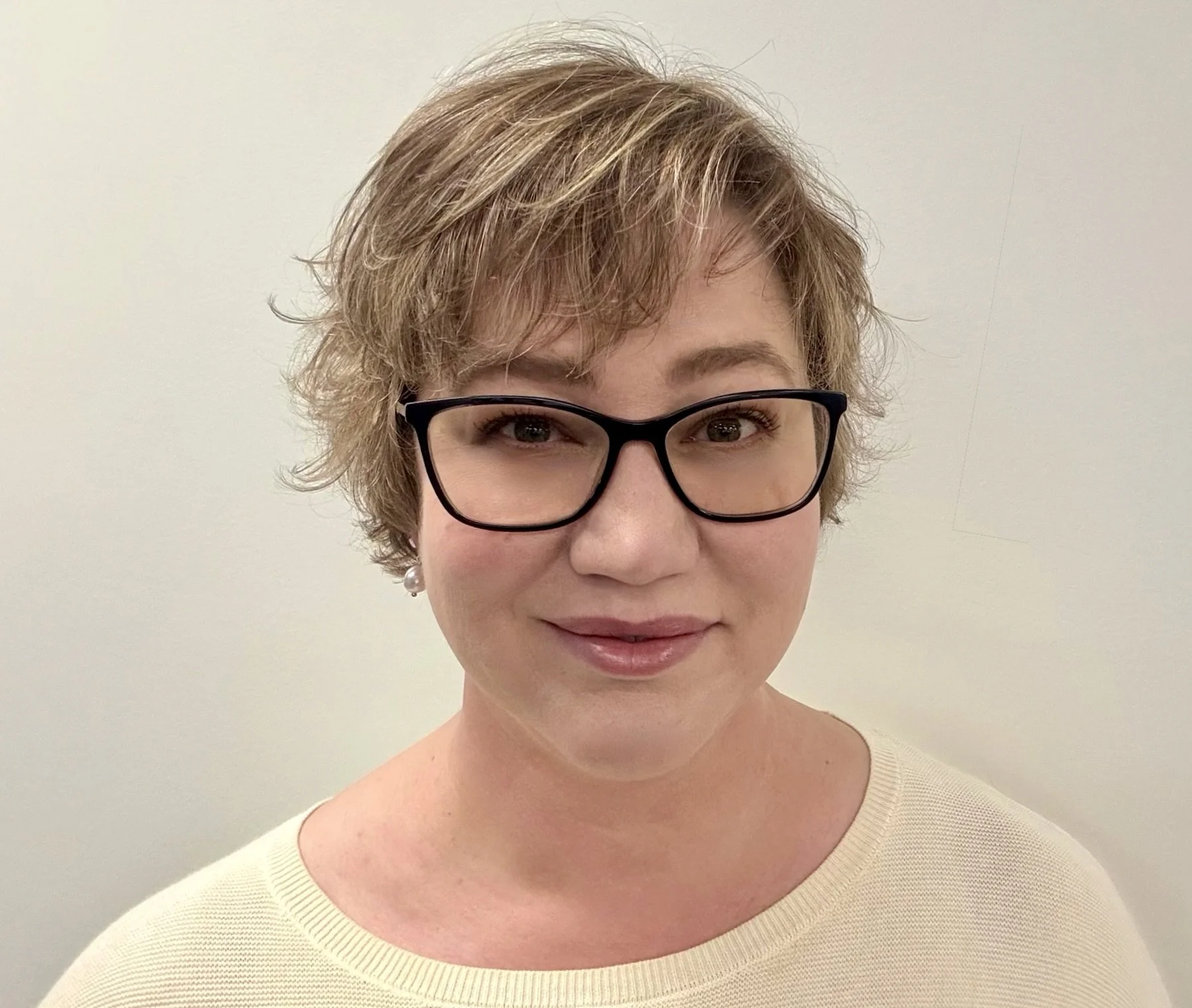 Portrait of Dr. Rachel Martin, smiling, with a neutral background