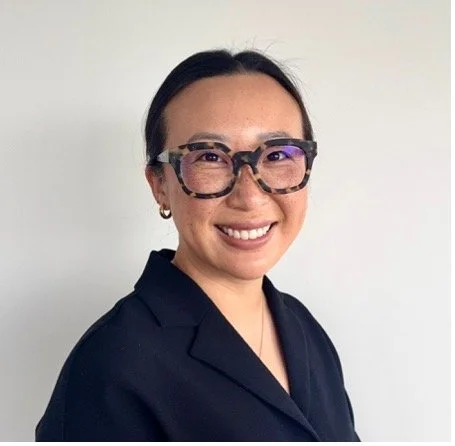 Portrait of Dr. Jenney Zhu, smiling, with neutral background