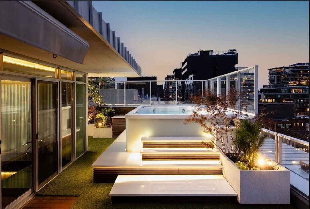1200 sq. ft. penthouse wrap- around terrace with 14' resistance pool. White corian hard-scaping and backlit laminated glass pool surround . Reflecting pool with illuminated corian water feature and porcelain tile stepping stones. Ipe decking with por