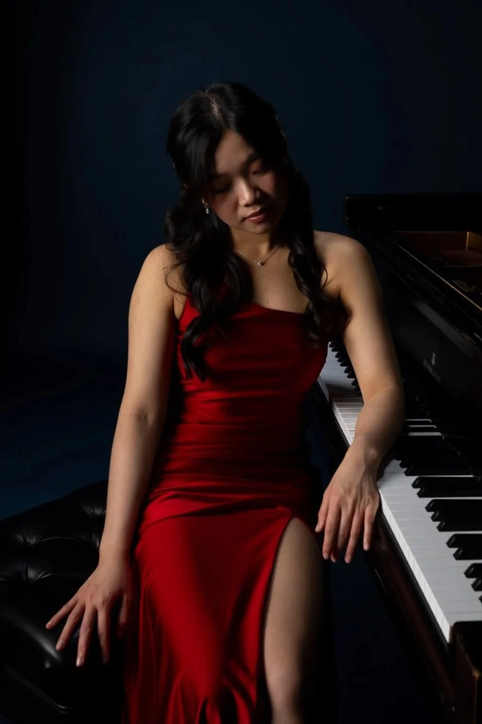 vivid ma in a red dress at the piano