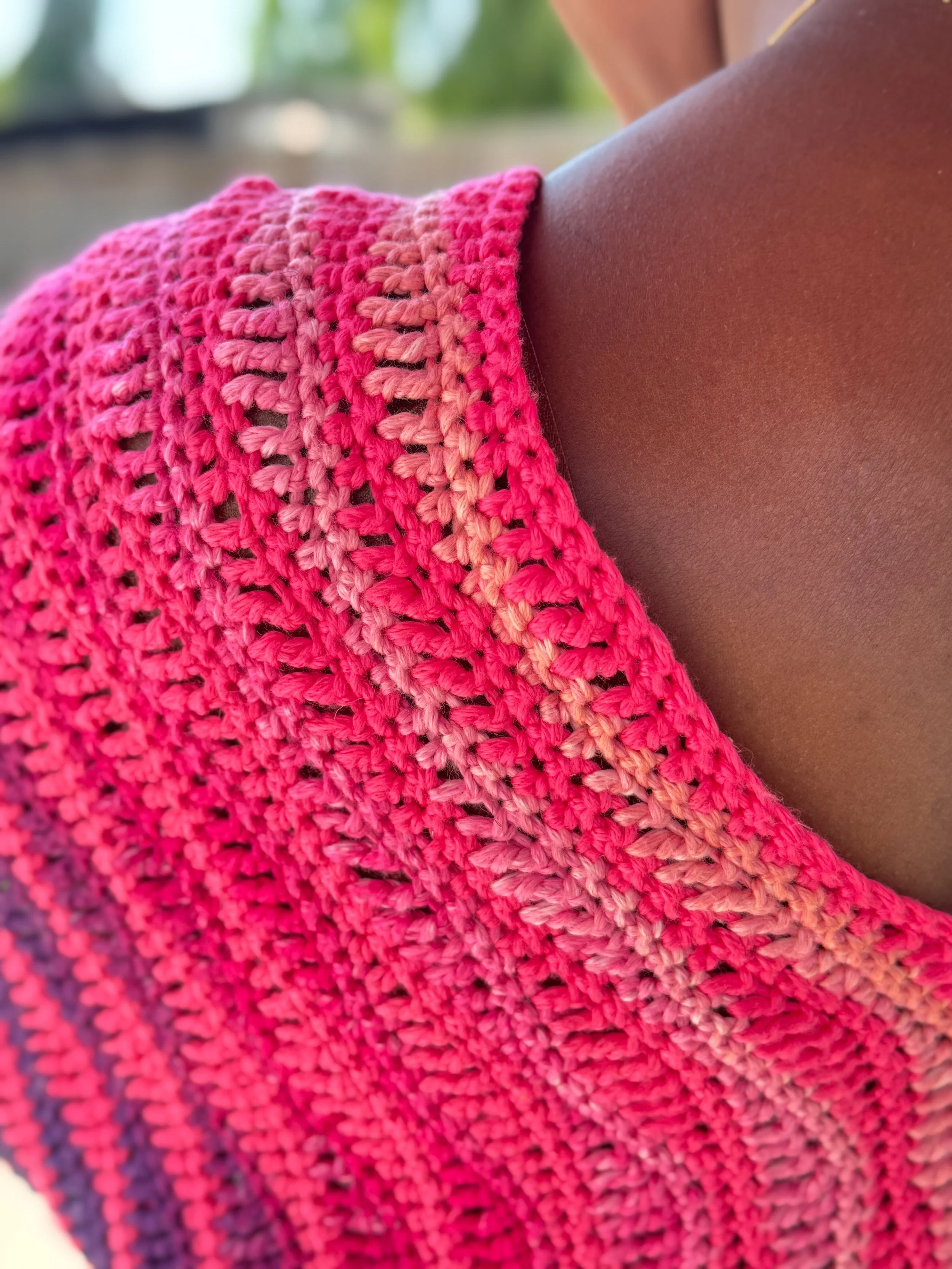 Pink and orange oversized crochet crop tee made with DK weight yarn, shown in a boxy fit with simple stitch texture and warm-weather styling.