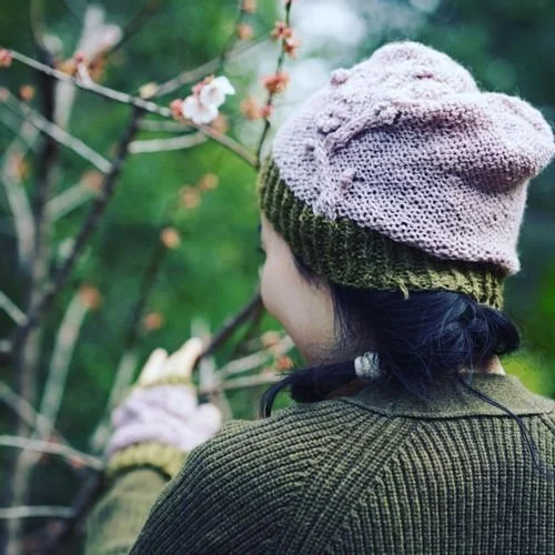 Tiffany Wong of Made @ Linden seen from behind in a lilac beret with an olive brim and a green sweater